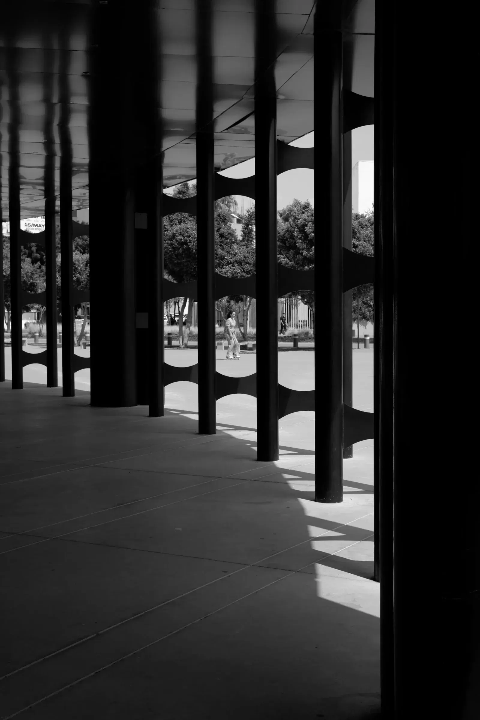 Geometric shadows across an arena walkway