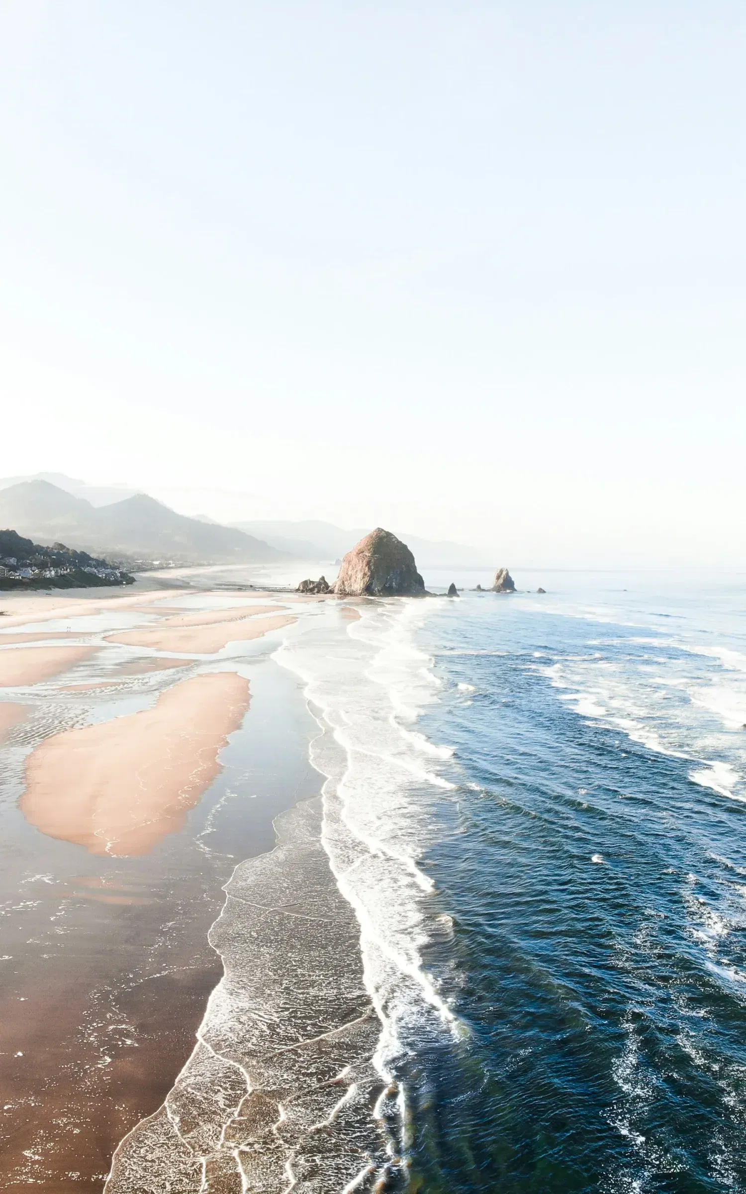 Ocean waves along a wide sandy beach on the Oregon coast